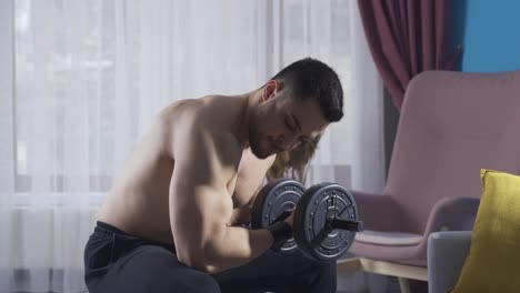 Young-man-working-out-his-body-with-fitness-equipment-at-home.